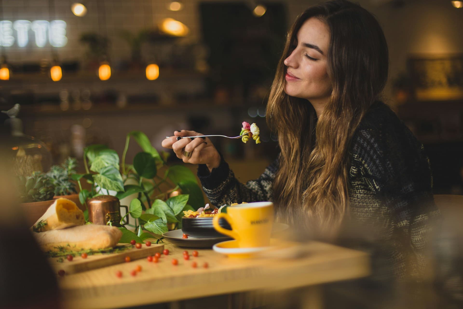 A guest enjoying a plated dish at a restaurant table