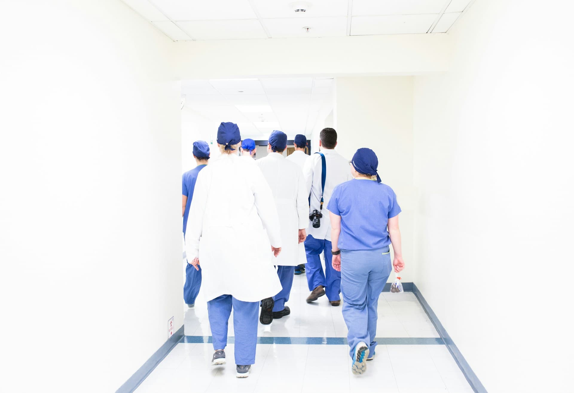 Grid of patient heart-rate monitors glowing in a clinical setting