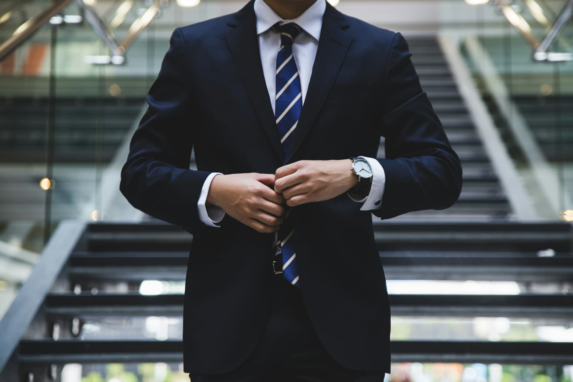 A retail executive in a tailored suit on the shop floor