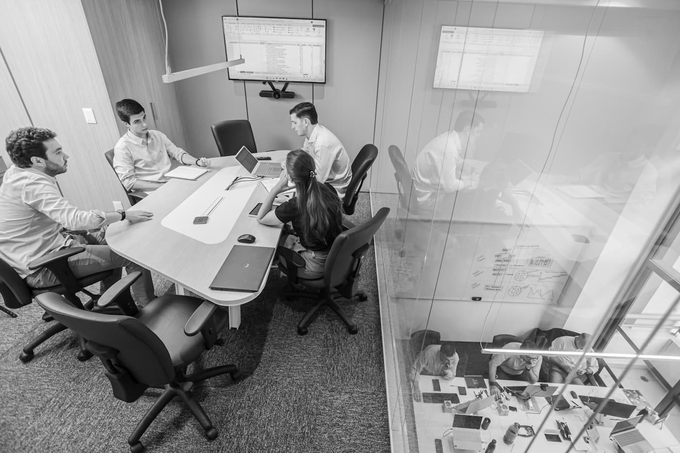 Healthcare information management team reviewing document retention workflow together in a conference room